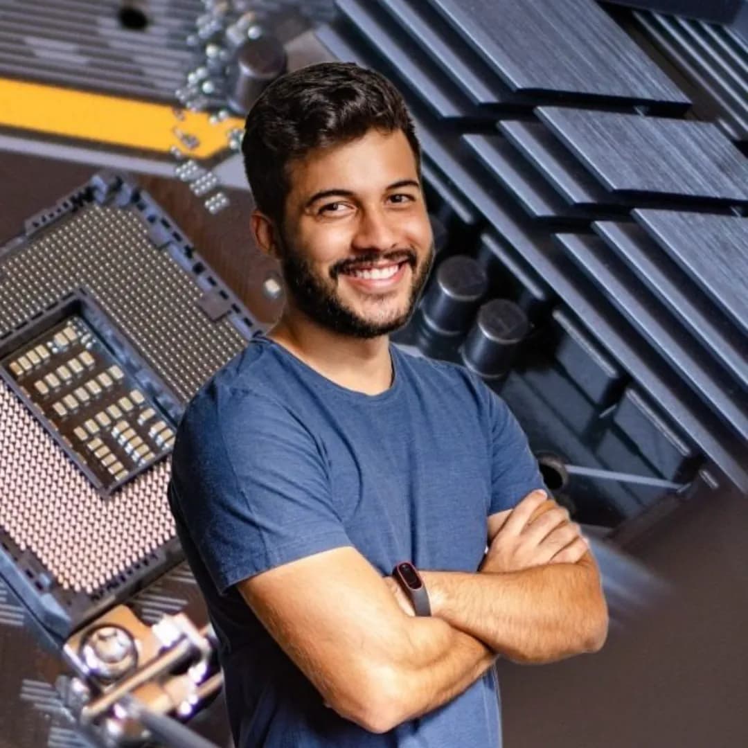 Square 1:1 crop of the same thumbnail: the smiling bearded man, head and folded arms, over the motherboard and its heatsinks.